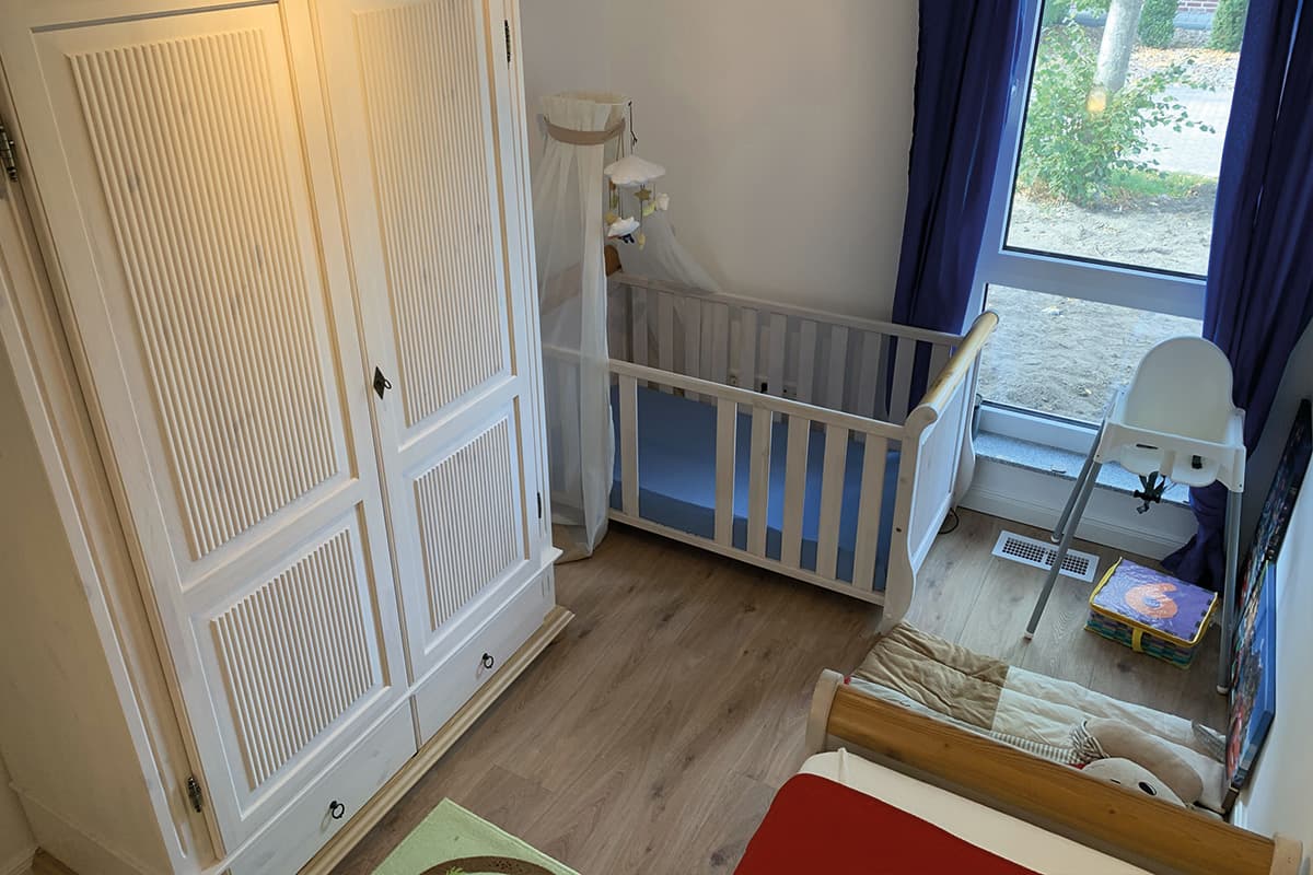 Kinderzimmer mit Babybett in dem Ferienhaus Linde1 in Winsen Aller